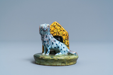 A polychrome Dutch Delft model of a dog by its doghouse, 18th C.