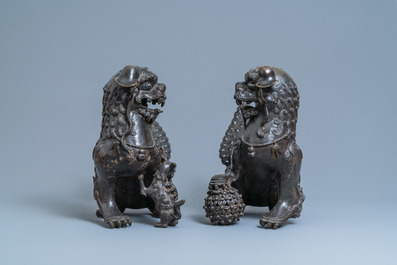 A pair of large Chinese bronze models of Buddhist lions, Ming