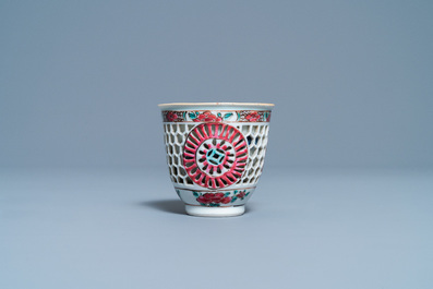 A Chinese reticulated double-walled famille rose cup and saucer, Yongzheng