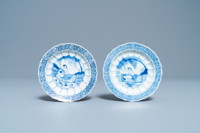 A pair of Chinese blue and white 'acupuncture' saucers, Kangxi