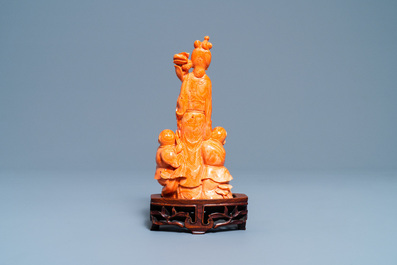 A Chinese carved red coral group of a lady with two boys, 19/20th C.