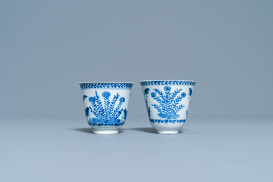 A pair of Chinese blue and white cups and saucers, Kangxi