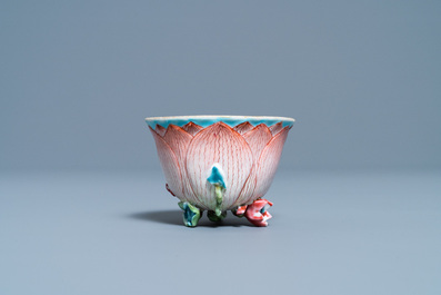 Een Chinese famille rose lotusvormige kop en schotel met reli&euml;fdecor, Yongzheng