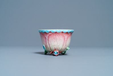 A Chinese famille rose 'lotus' cup and saucer with applied design, Yongzheng