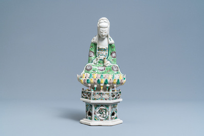 A Chinese verte biscuit group of Guanyin on a lotus throne, Kangxi