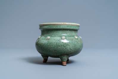 A Chinese monochrome celadon and crackle-glazed tripod censer, Ming