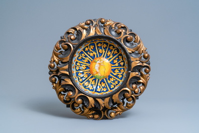 Two polychrome Italian maiolica crespina in finely carved wooden frames, Faenza and Montelupo, 16/17th C.