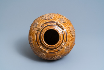 A Chinese brown-glazed relief-molded martaban jar with floral panels, Qing