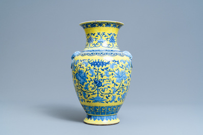 A Chinese blue and white yellow-ground vase with floral design, 19th C.