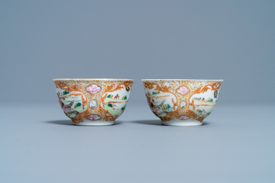 A pair of Chinese gilded famille rose 'Mongolian hunt' cups and saucers, Qianlong