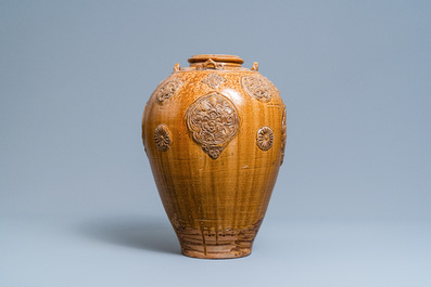 A Chinese brown-glazed relief-molded martaban jar with floral panels, Qing