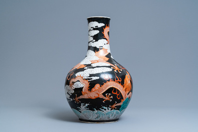 A Chinese famille noire 'dragon' bottle vase, 19th C.