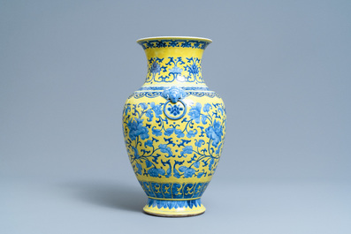 A Chinese blue and white yellow-ground vase with floral design, 19th C.