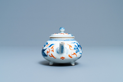 A Chinese blue, white, iron red and gilt tripod teapot and cover, Kangxi