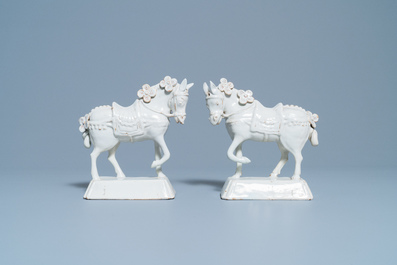 A pair of white Dutch Delftware models of horses, 18th C.