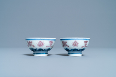 A pair of Chinese blue, white and copper red 'bajixiang' tea bowls, 4-character mark, 19/20th C.