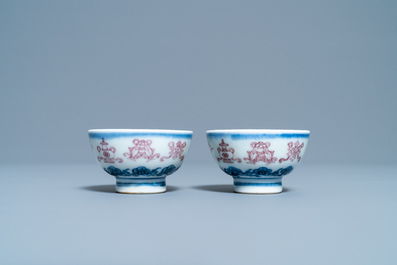 A pair of Chinese blue, white and copper red 'bajixiang' tea bowls, 4-character mark, 19/20th C.