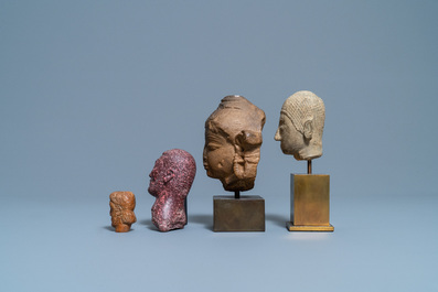 Four various carved stone heads, 17th C. and later