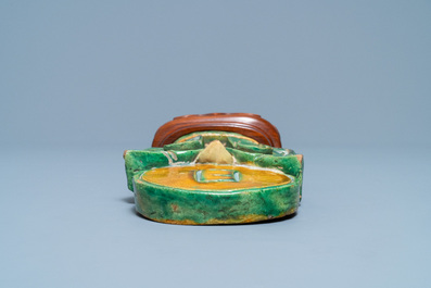 A Chinese sancai-glazed Buddhist emblem on wooden stand, Ming