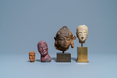 Four various carved stone heads, 17th C. and later