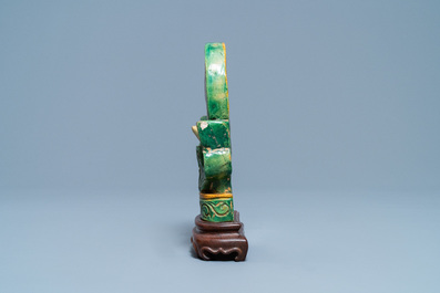 A Chinese sancai-glazed Buddhist emblem on wooden stand, Ming