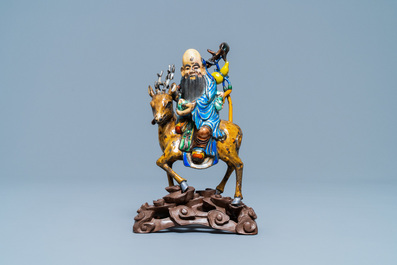 A Chinese enamelled silver figure of Shou Lao on a deer, 19th C.