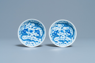 A pair of Chinese blue and white 'dragon' saucers, Kangxi mark, 19th C.