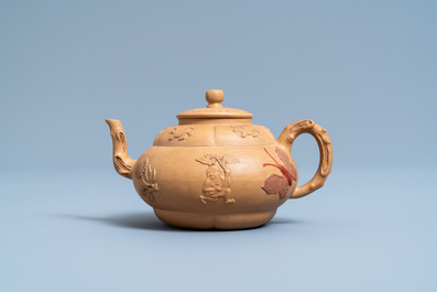 A bichrome Chinese Yixing stoneware teapot and cover with applied design, Kangxi