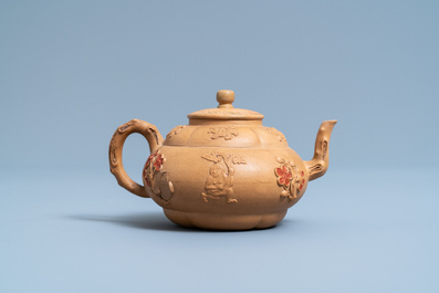 A bichrome Chinese Yixing stoneware teapot and cover with applied design, Kangxi