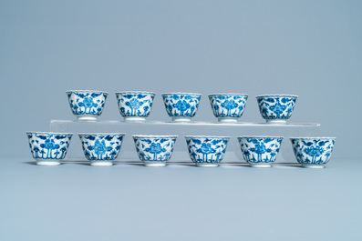 Seventeen Chinese blue and white cups and twenty-two saucers with floral design, Kangxi