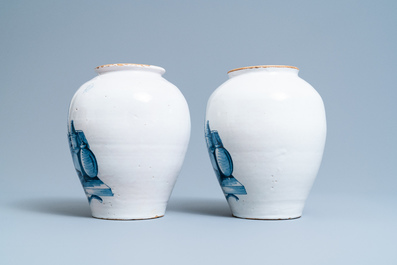 A pair of Dutch Delft blue and white tobacco jars with a trader, 18th C.