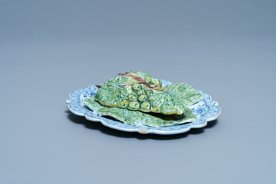 A polychrome Dutch Delft bunch of grapes on a dish, 18th C.