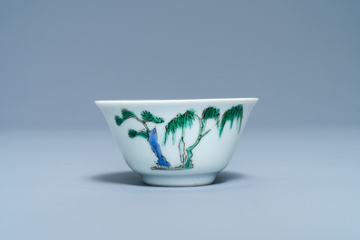 A Chinese famille verte 'erotical subject' cup and saucer, Kangxi