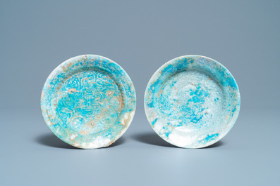 A pair of turquoise-glazed relief-decorated plates, Raqqa, Syria, 13/14th C.