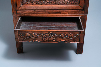 A Chinese hongmu cupboard with a blue and white 'Buddhist lions' plaque, 19th C.