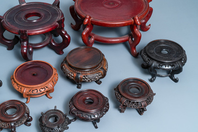 Twelve large round Chinese carved wooden stands, 19/20th C.