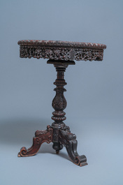 A Chinese carved wooden table with a large Canton famille verte plaque, 19th C.