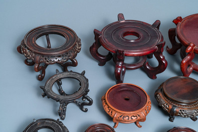 Twelve large round Chinese carved wooden stands, 19/20th C.