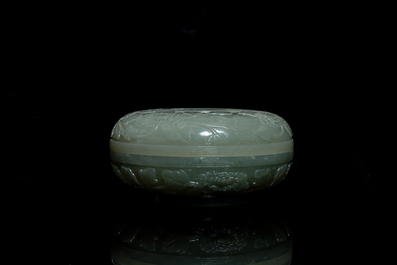 A Chinese pale celadon jade 'phoenix and peony' circular box and cover, 19th C.