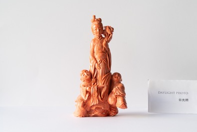 A Chinese carved red coral group of a lady with two boys, 19/20th C.