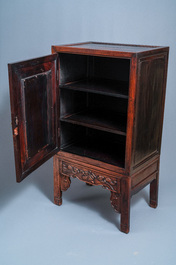 A Chinese hongmu cupboard with a blue and white 'Buddhist lions' plaque, 19th C.
