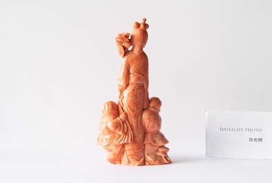 A Chinese carved red coral group of a lady with two boys, 19/20th C.