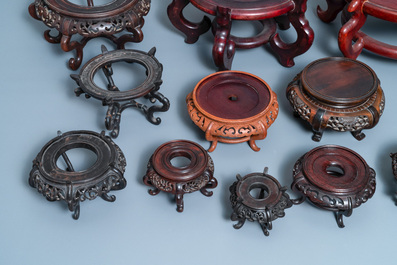 Twelve large round Chinese carved wooden stands, 19/20th C.