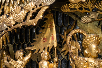 A Chinese gilded wood carving on matching pillars, 19th C.