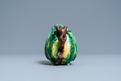 A Chinese verte biscuit peach-shaped 'cadogan' teapot, Kangxi