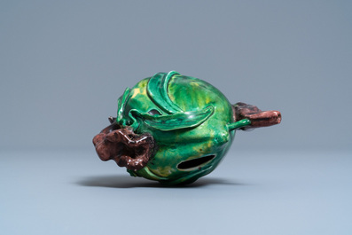 A Chinese verte biscuit peach-shaped 'cadogan' teapot, Kangxi