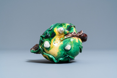 A Chinese verte biscuit peach-shaped 'cadogan' teapot, Kangxi