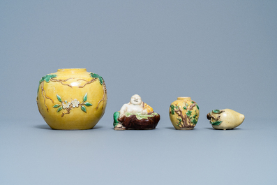 Two Chinese yellow and verte biscuit jars, a Buddha figure and a peach-shaped brush washer, 19/20th C.