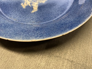 A Chinese blue, white and copper red powder blue-ground dish, Kangxi