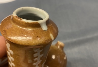 A rare Chinese slip-decorated brown-ground Swatow kendi, Ming